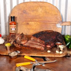 Cooper's Old Time Pit Bar-b-que mail order tradition box includes one brisket (4lb average), two pork chops, and one bottle of BBQ sauce.